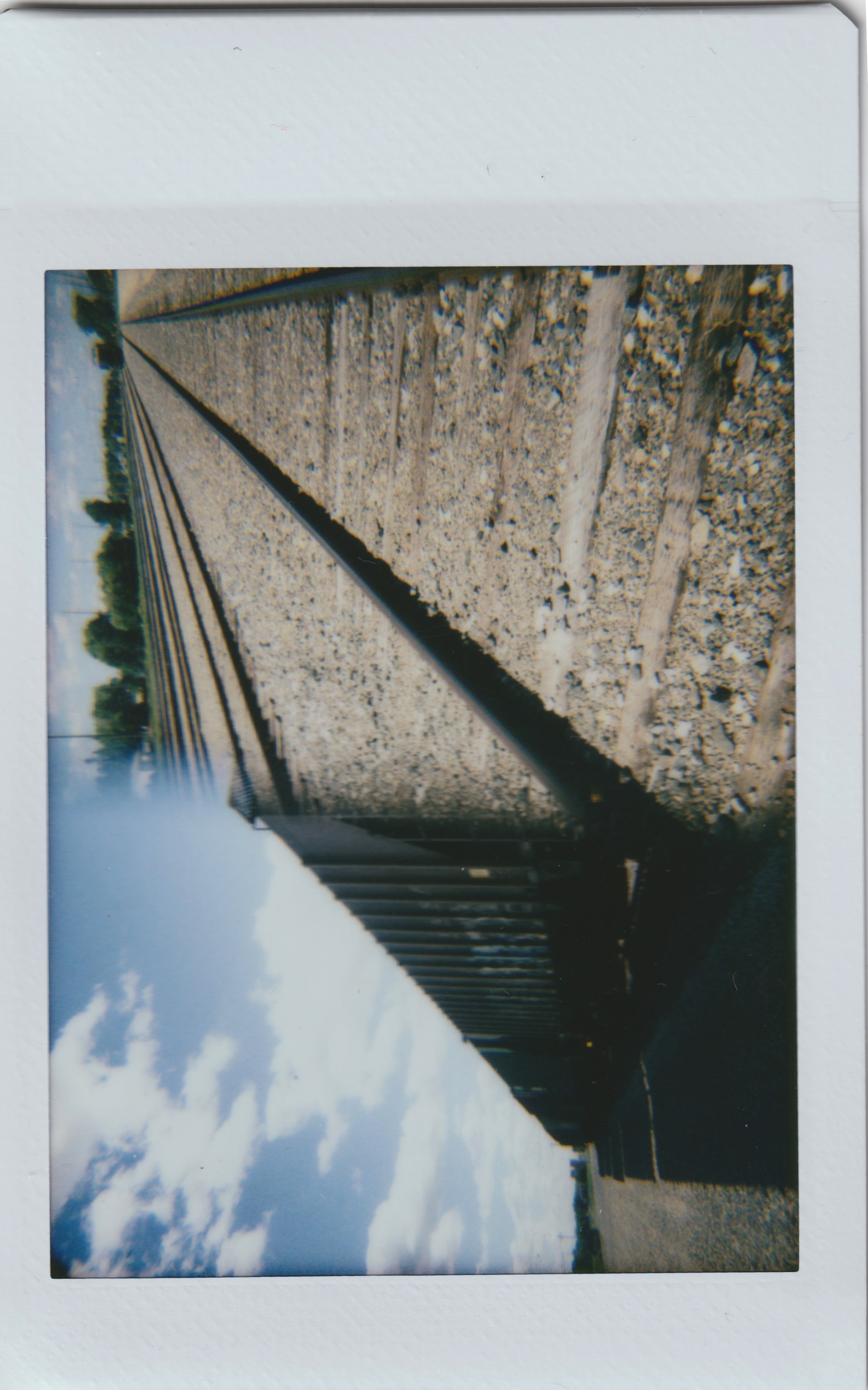 a split shot with a rail car on the left and tracks on the right