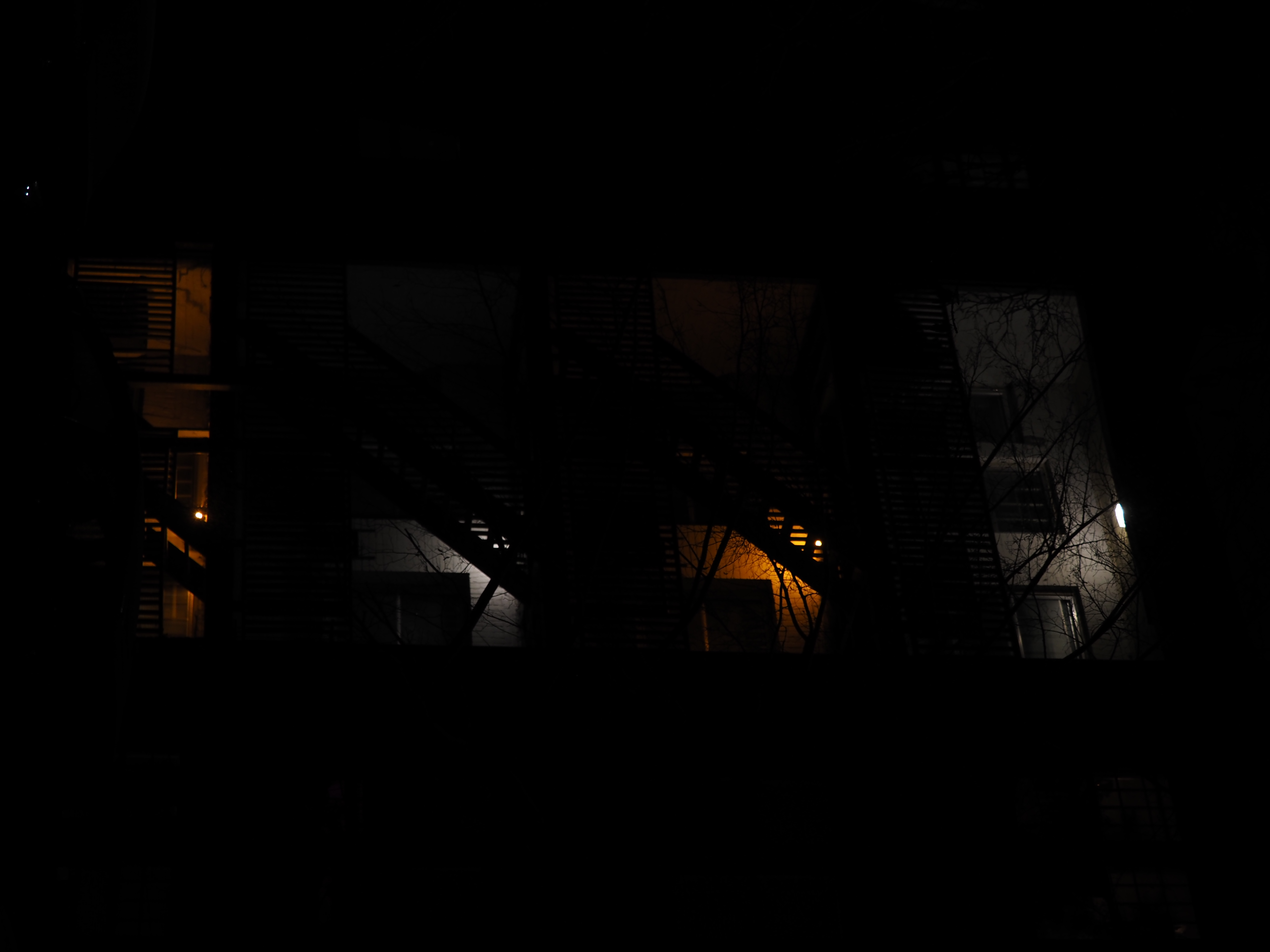 a multi-storied building with different coloured lights