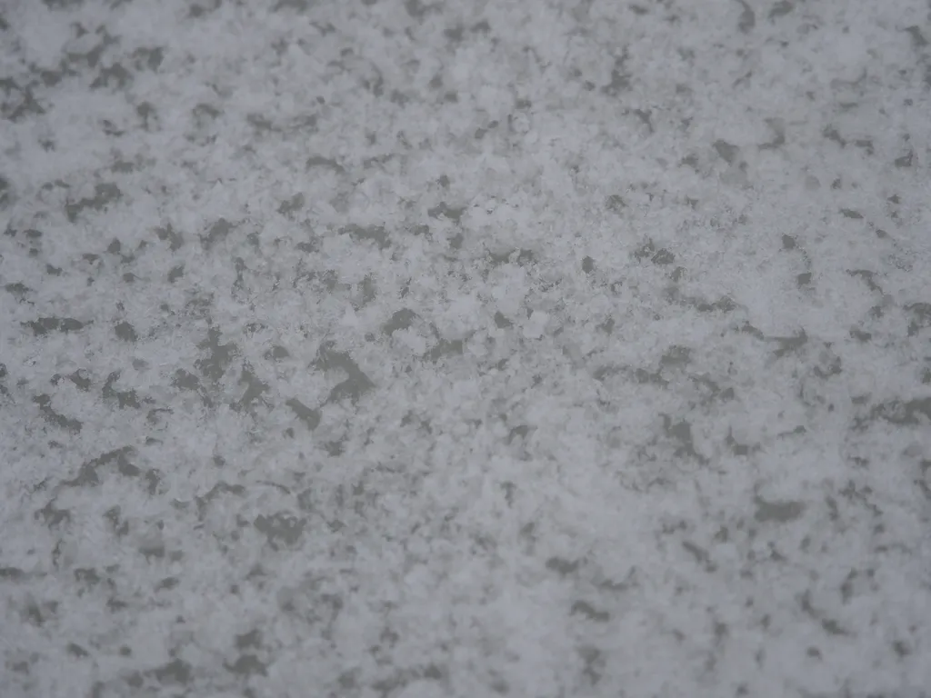 the uneven surface of a cleared section of ice on the river