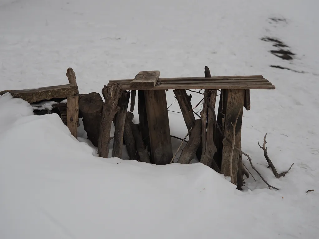 a makeshift pier jutting out of the snow