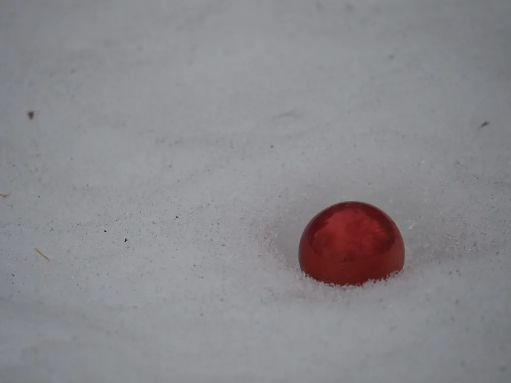 an ornament sitting in icy snow