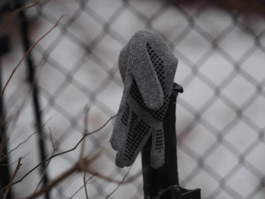 a black glove on the end of a fence