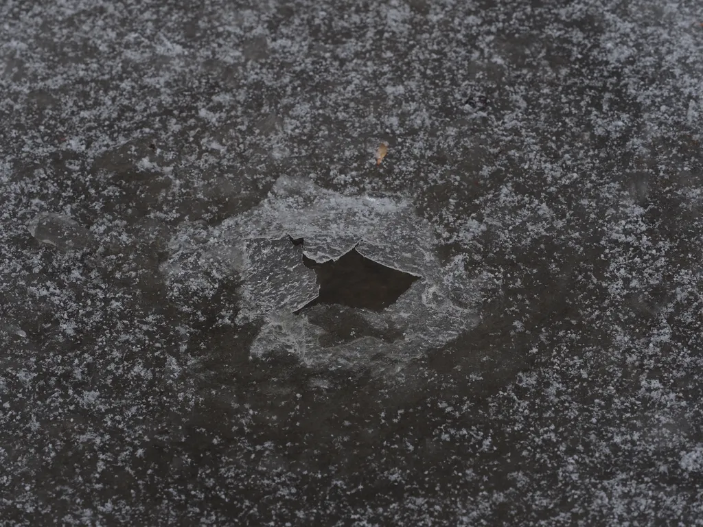 a hole in a frozen puddle