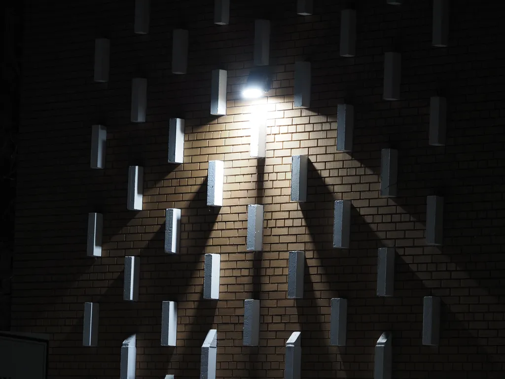 blocks on a wall casting shadows at night