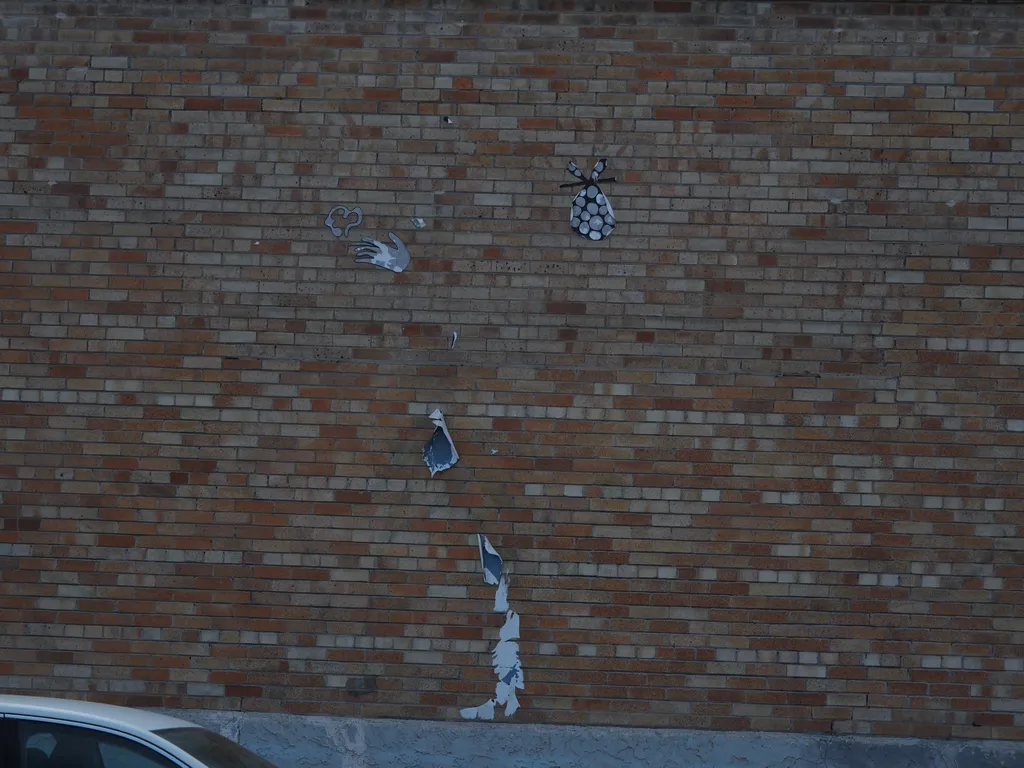 the remains of drawing of a hobo that had been pasted on a wall