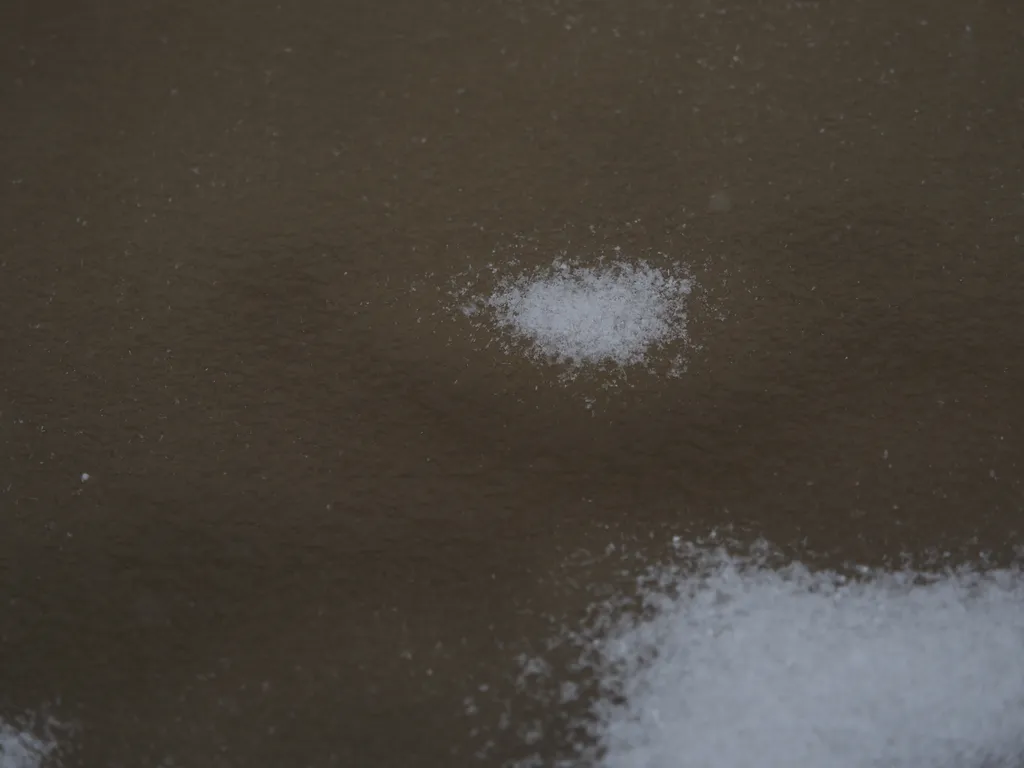 fresh snow on a slushy puddle