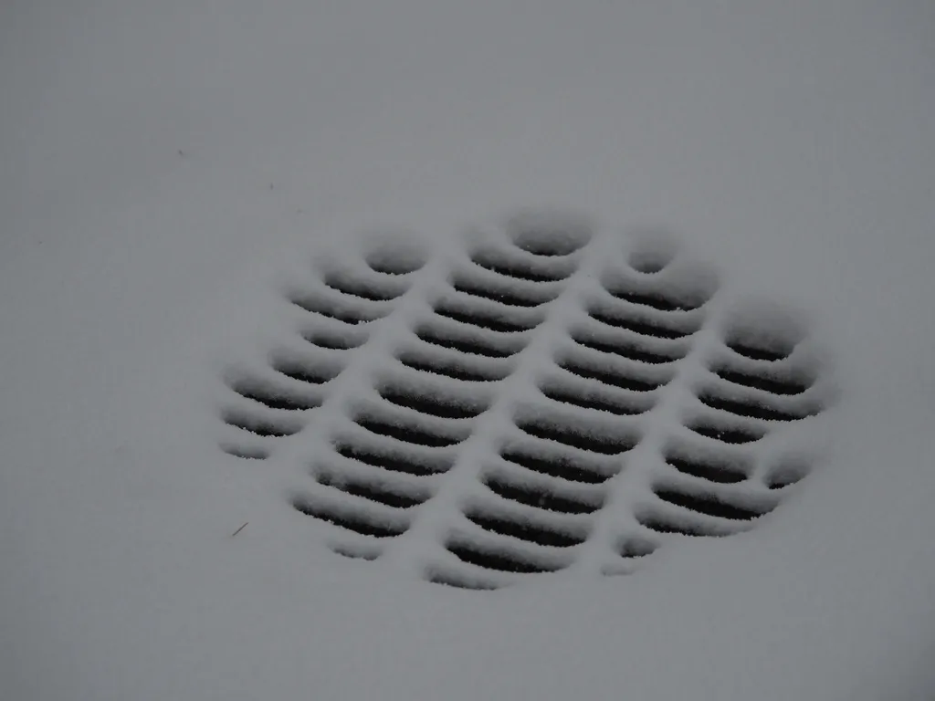 snow covering a storm drain