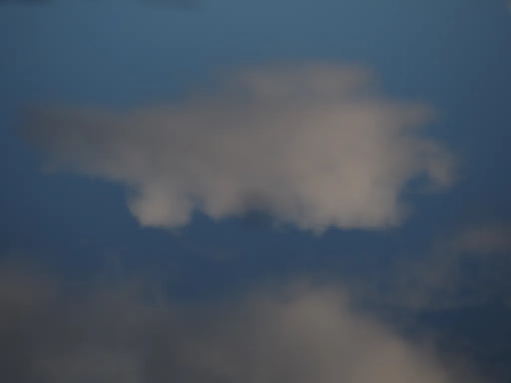 a cloud reflected in a puddle