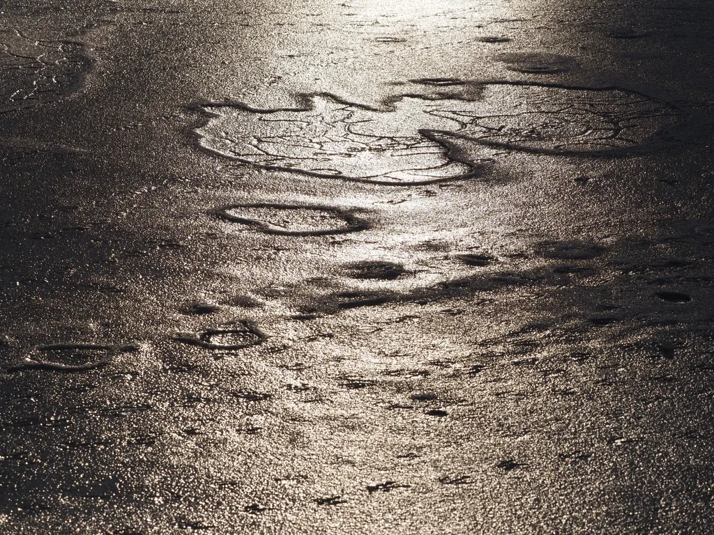 the sun reflecting on a frozen river