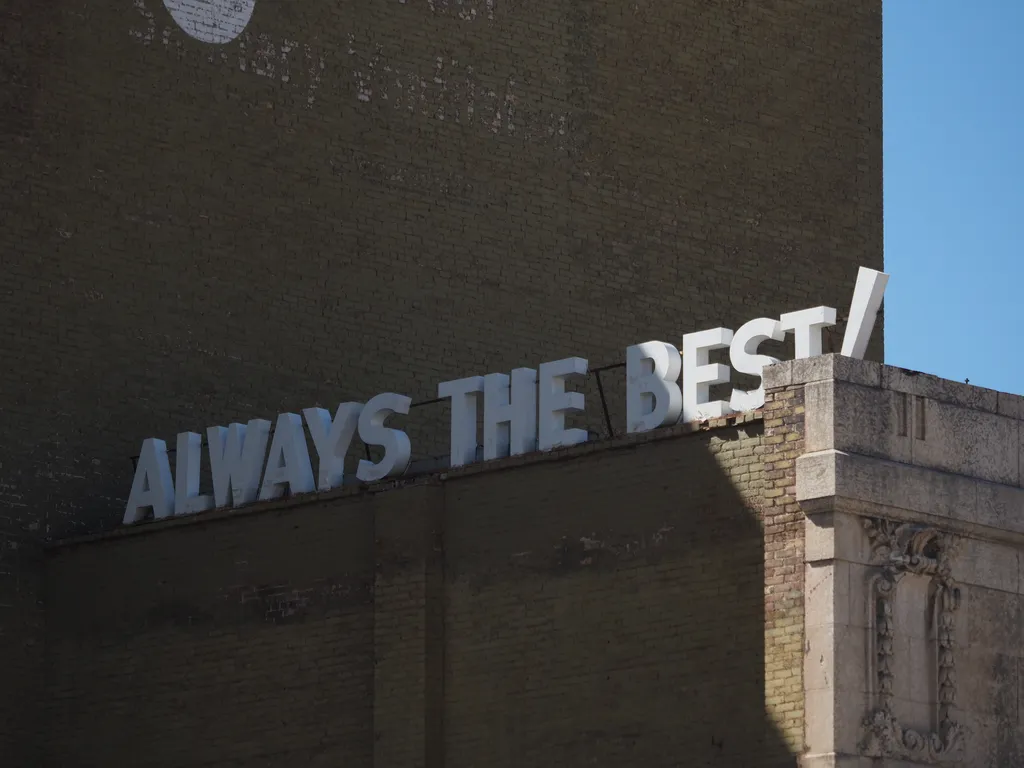 a sign on a brick building: always the best!