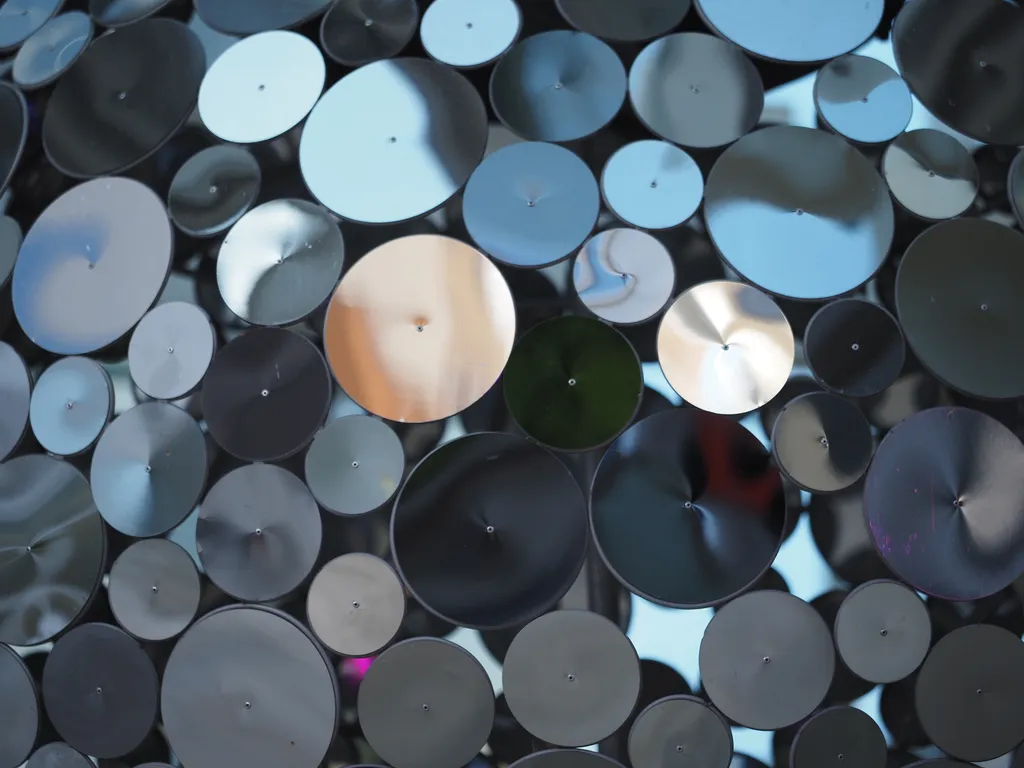a disco ball made of round metal discs on poles