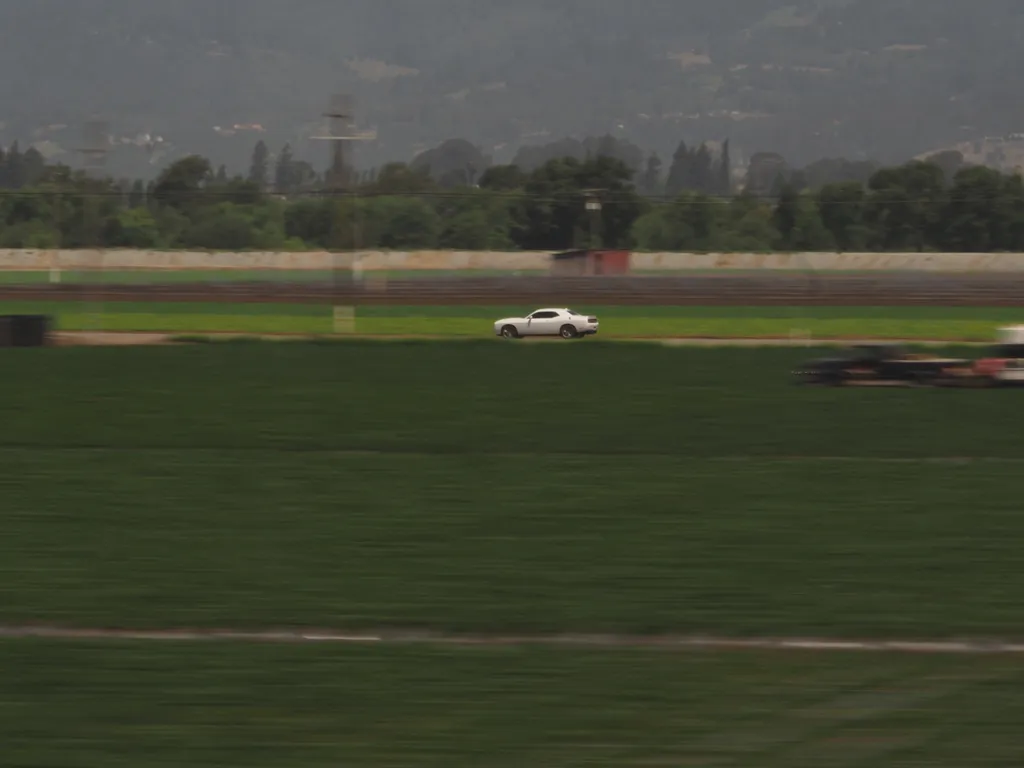 a car driving parallel to a train