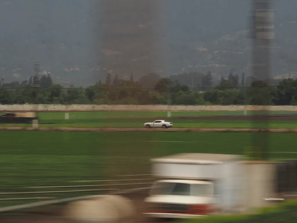 a car driving parallel to a train