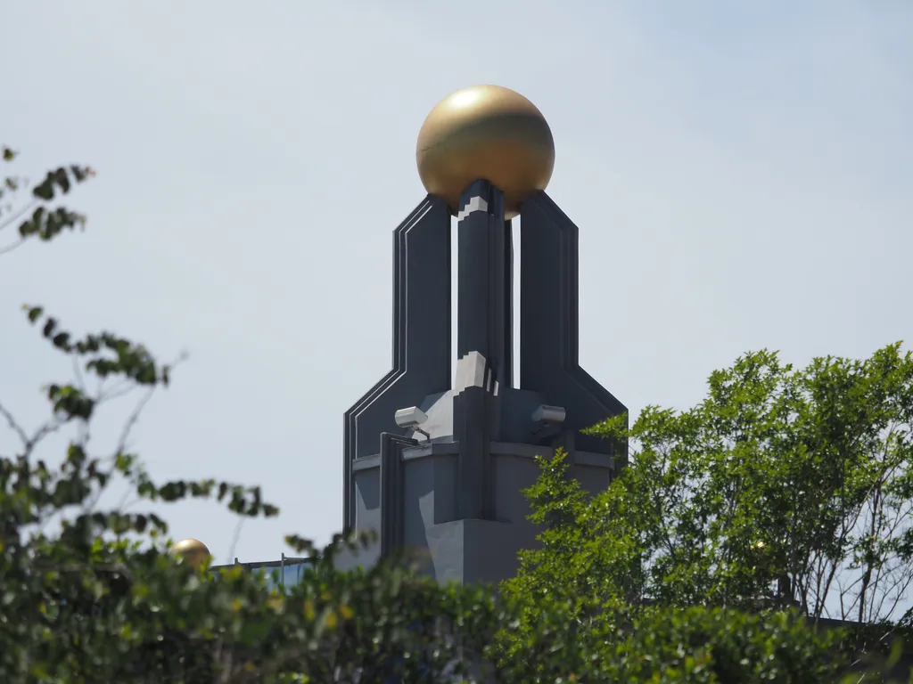 a large gold orb at the tip of a movie theatre