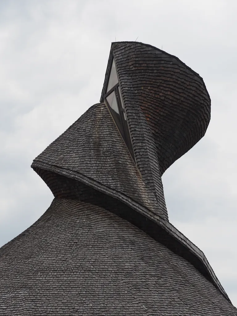 the spiral shingle roof of a parish