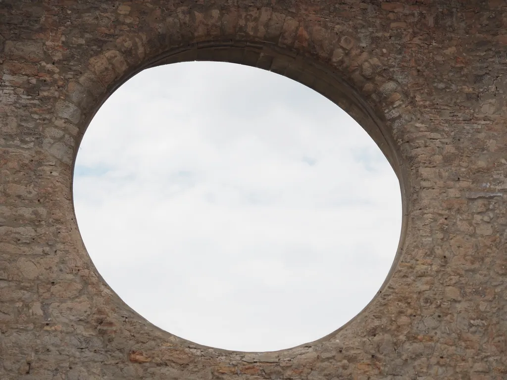 the void left from a missing stain glass window in a cathedral