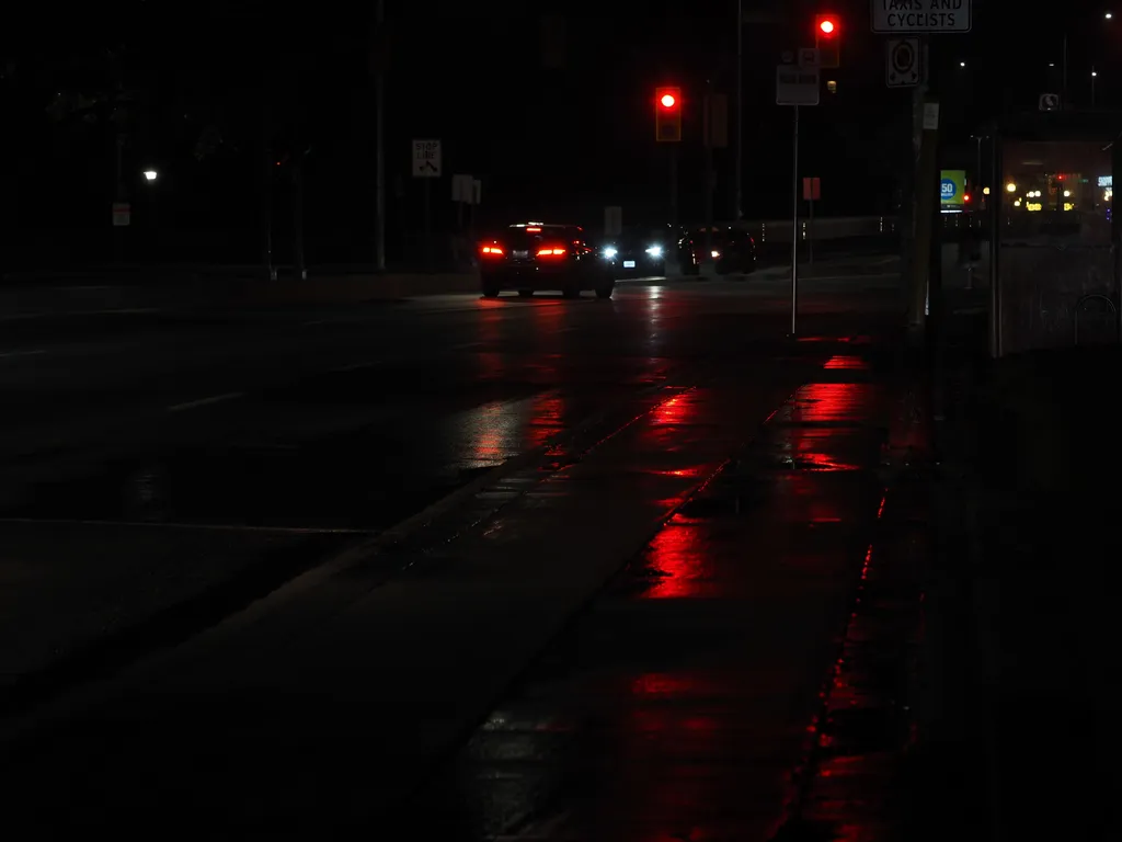 lights reflecting on a wet street at night