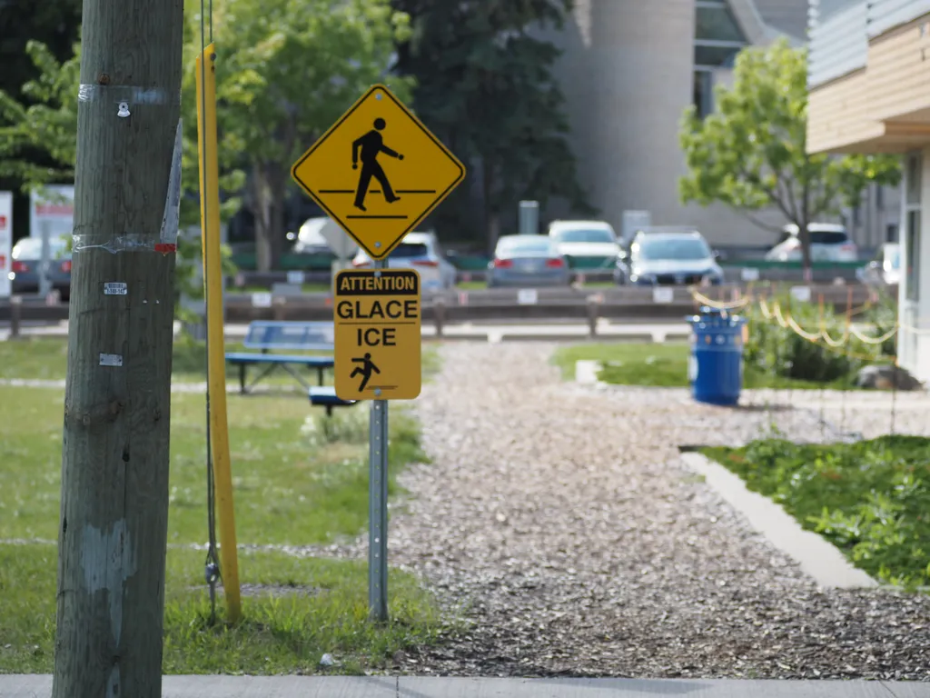 a sign warning of slippery ice in the middle of summer