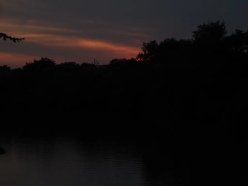 the sun setting over a river