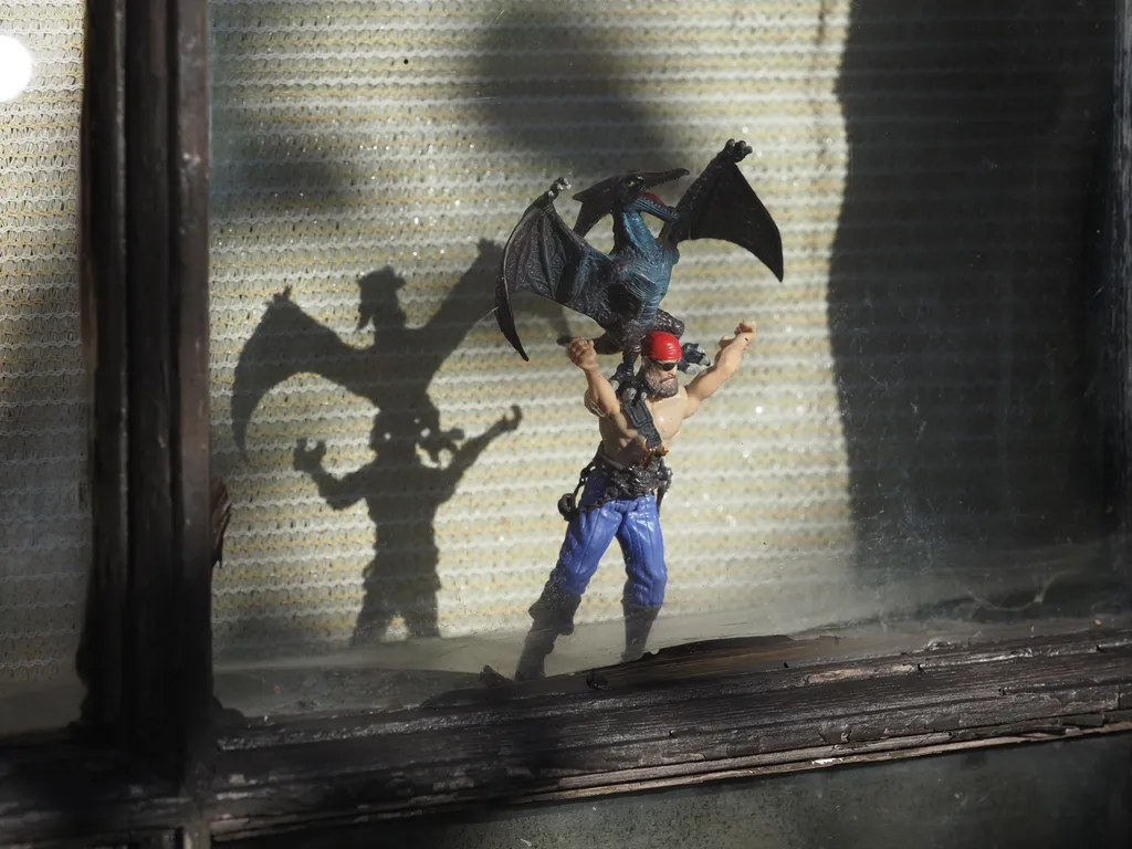 a pair of toys: a pterodactyl attacking a pirate