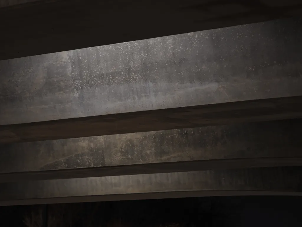 the underside of a bridge at night