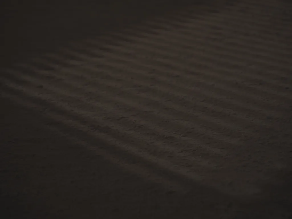 shadows from the railing of a bridge