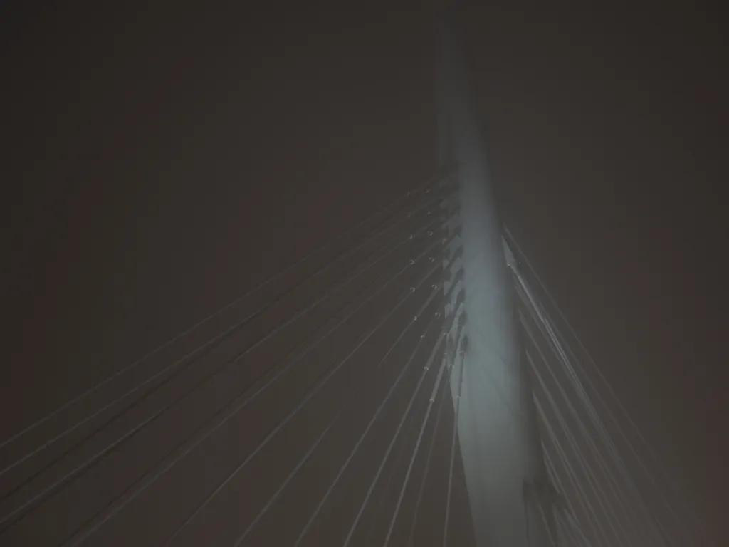 a bridge on a foggy night