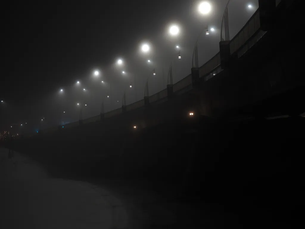 a bridge on a foggy night
