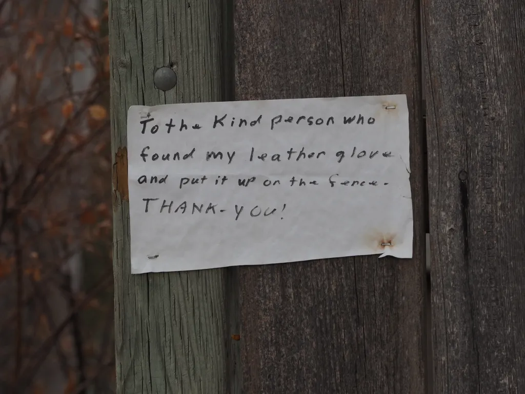 a message on a fence: to the kind person who found my leather glove and put it up on the fence. Thank-you!
