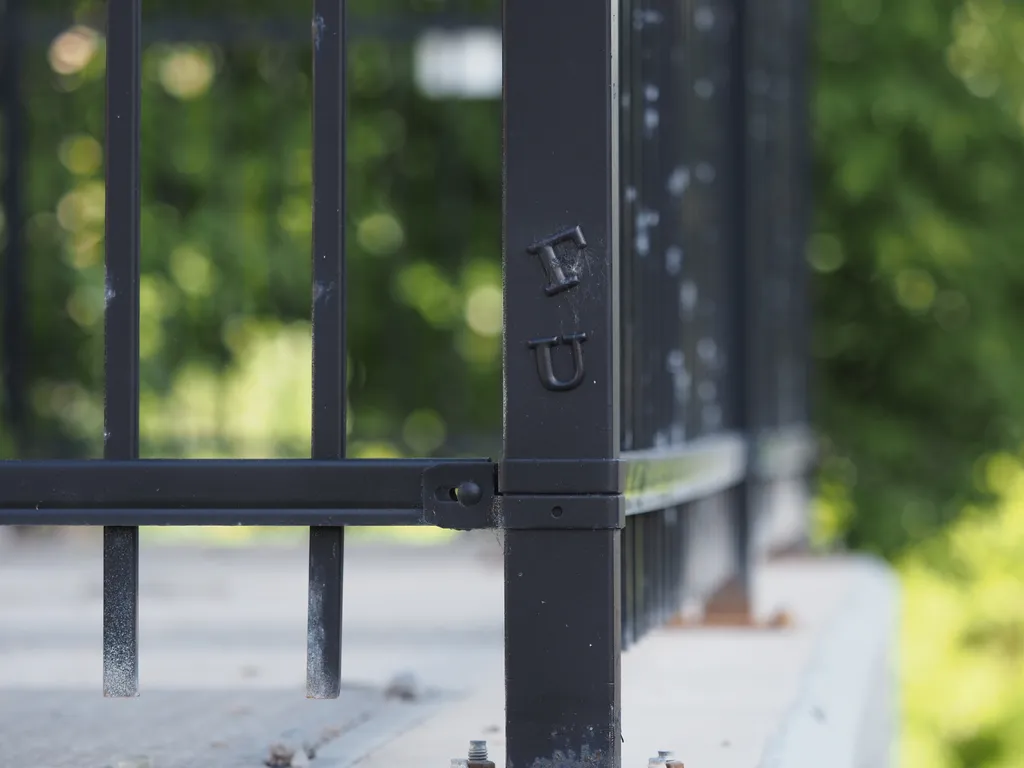 letters stuck on a fence 'f' 'u'